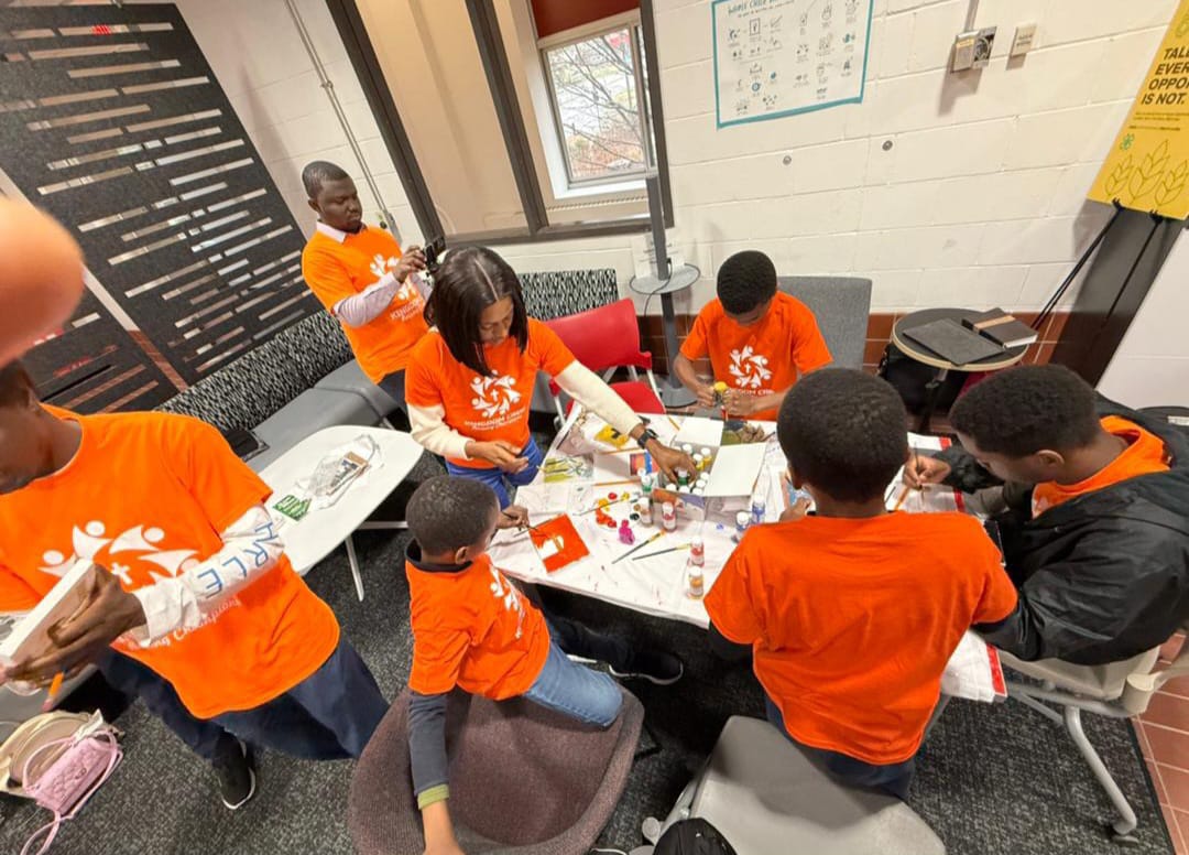 Kingdom Crew participants gathered around a table for creative painting