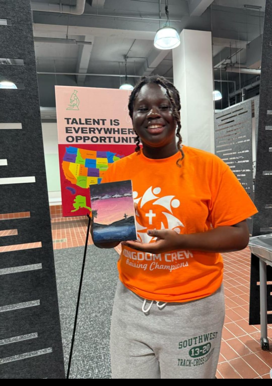 Kingdom Crew participant beside a talent and opportunity poster