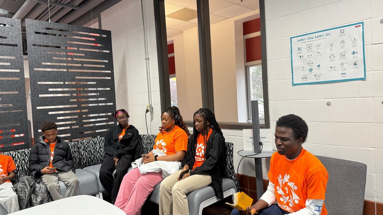 Kingdom Crew youths seated together during a reflective moment